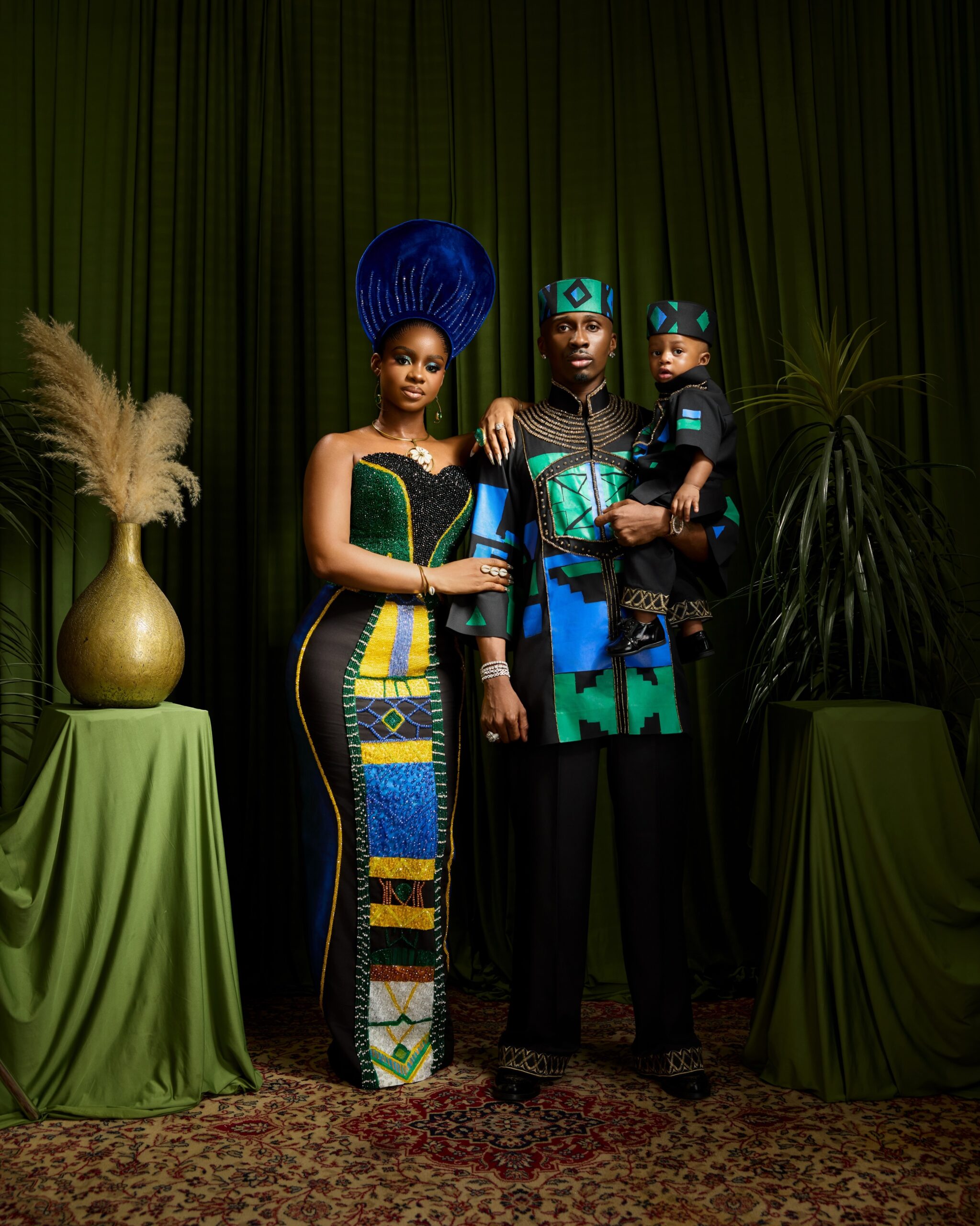 A coordinated family photoshoot celebrating a child's first birthday with traditional African fashion and geometric patterns