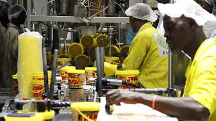 Nigerian factory workers managing production amid rising credit costs and operational challenges
