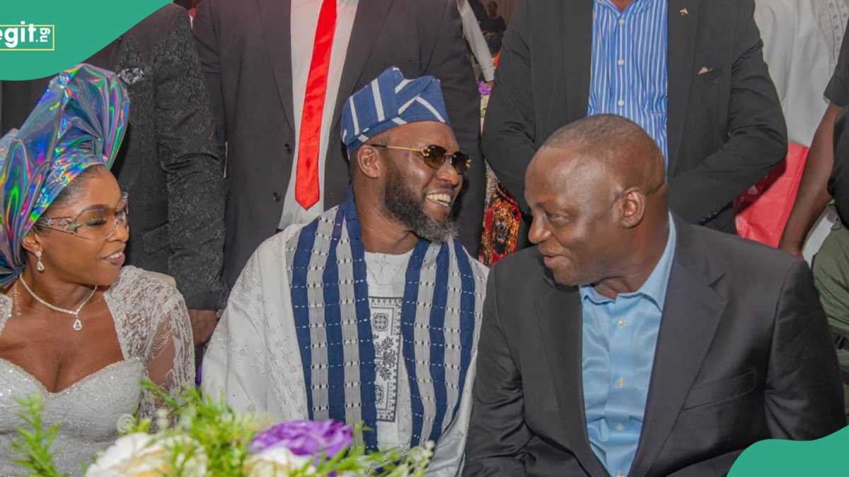 A festive Abuja event hall in the evening, adorned with Nigerian-inspired decorations and bustling with dignified guests celebrating a milestone birthday.
