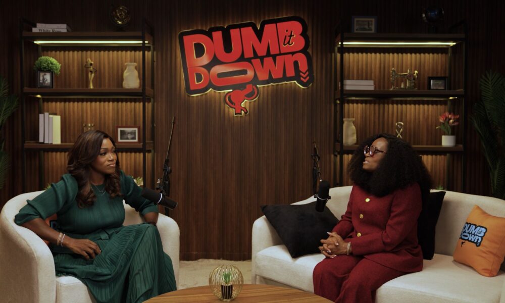 A vibrant Lagos street scene at dusk with a retro TV displaying the 'Dumb It Down' logo, symbolizing African storytelling and entertainment.
