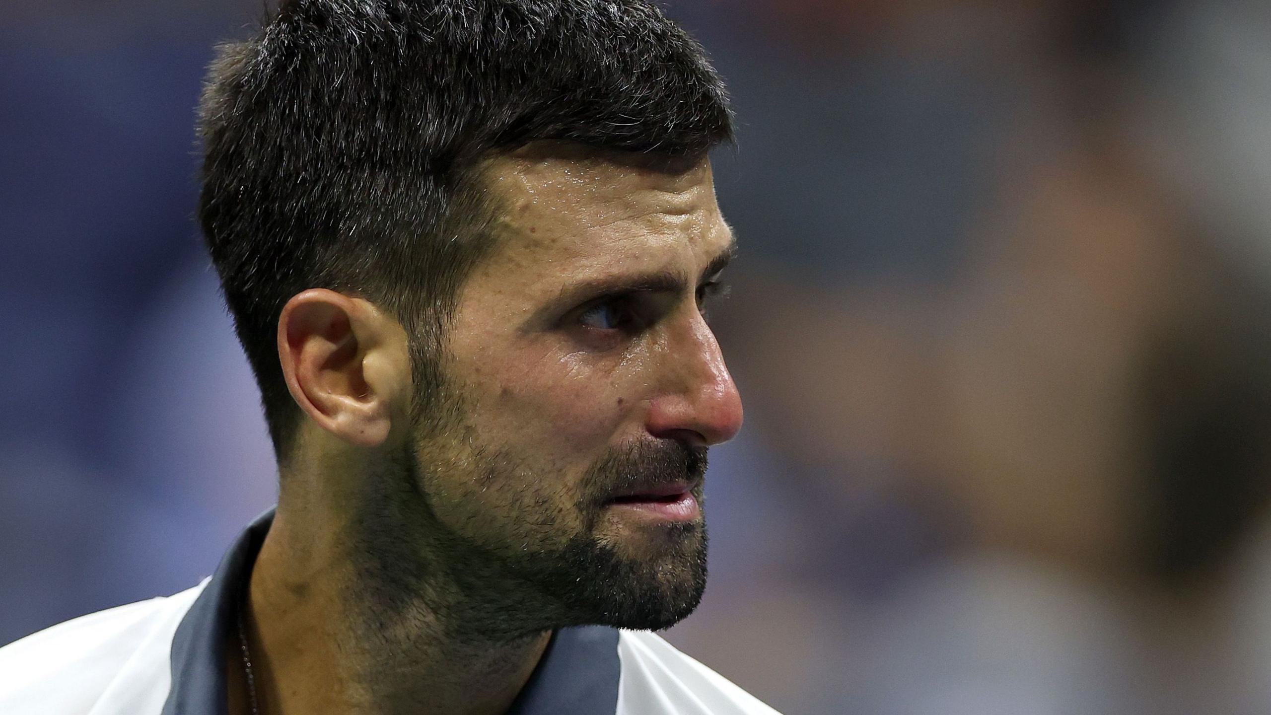 A symbolic tennis court at sunset, representing a moment of reflection after Djokovic's historic US Open loss.