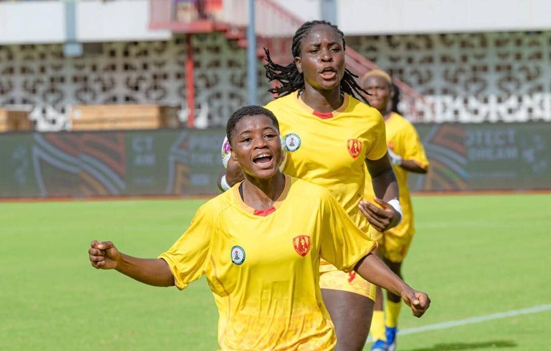 Edo Queens players celebrating a goal during a CAF Women’s Champions League qualifier, with fans in the background cheering.