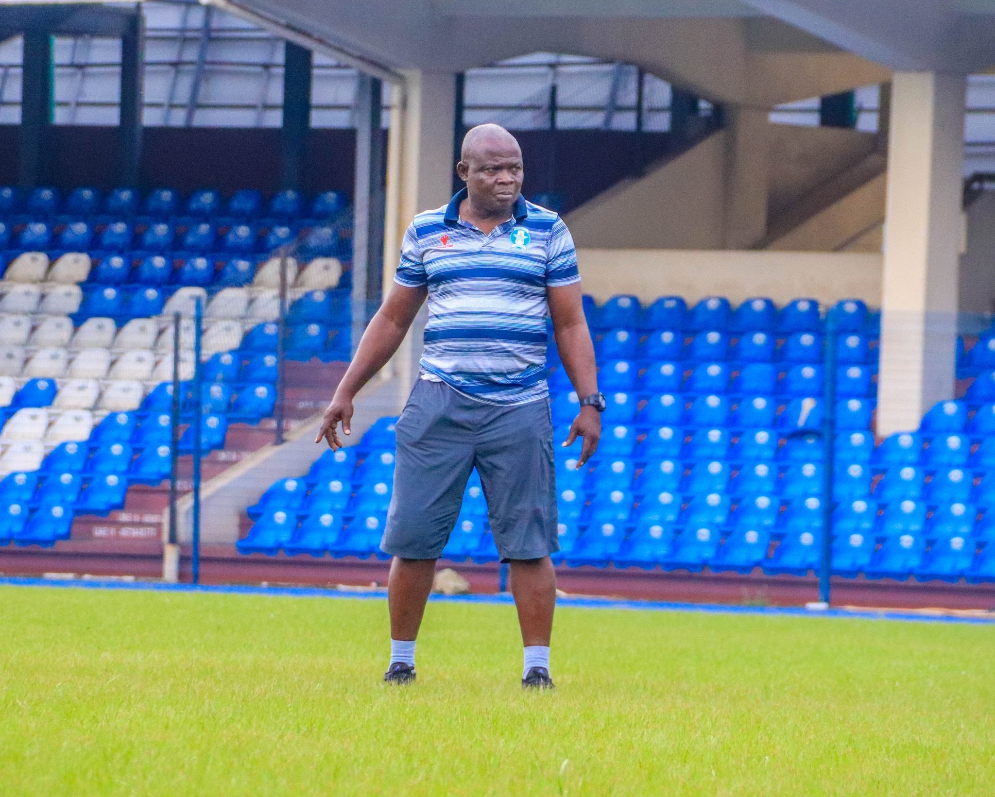 Close-up of an uneven football pitch with visible wear and tear, symbolizing poor playing conditions at the Adokiye Amiesimaka Stadium.