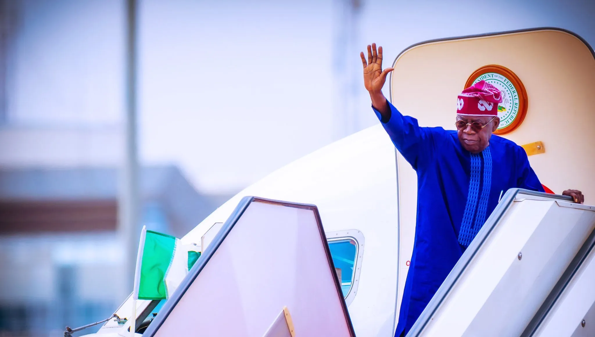 A private jet taking off from Abuja's international airport with Aso Rock in the background, symbolizing President Tinubu's departure for Europe during his annual leave in 2026.