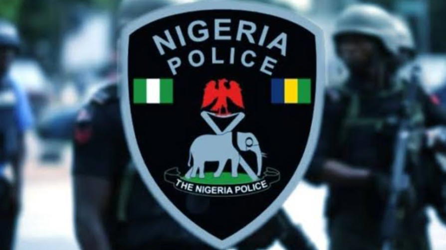 Police officers secure the Gusau-Funtua Federal Highway after foiling a bandit ambush, with civilians and recovered weapons visible in the background.