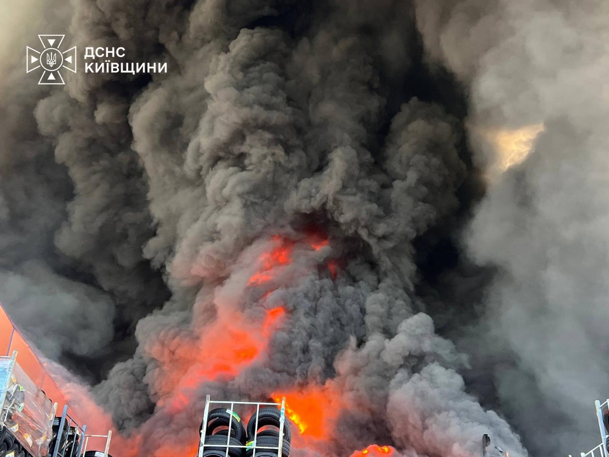 Aerial view of Kyiv skyline with visible damage and emergency response activity after a Russian strike.