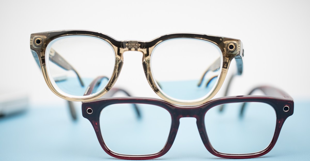 Close-up of a stylish pair of transparent smart glasses on a wooden surface with soft lighting