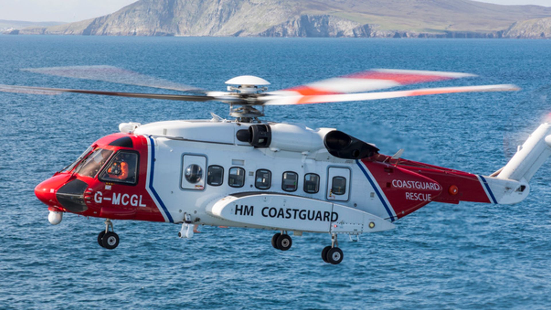 Coastguard vessel and helicopter coordinating a rescue operation in the English Channel during a maritime emergency