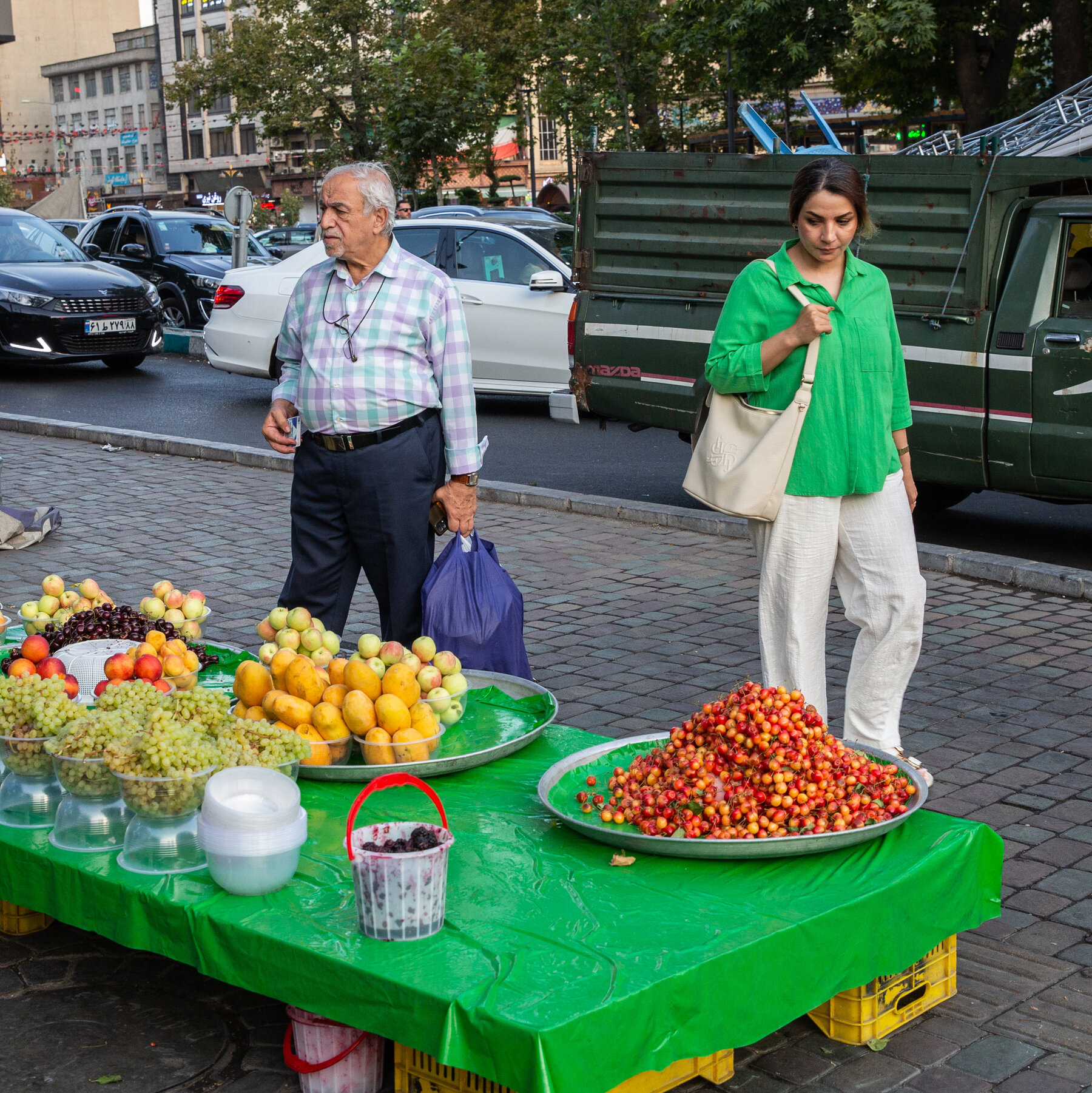 A quiet Tehran street at dusk, reflecting economic strain and war fatigue among Iranians.