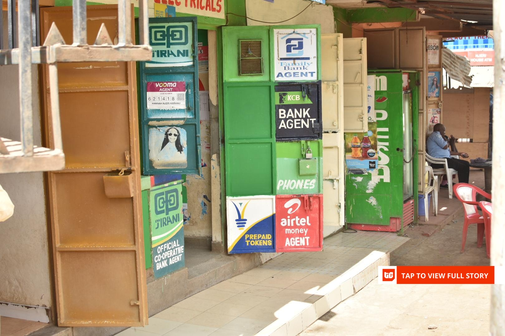 Kenyan market kiosks where mobile money agents operate, juxtaposed with digital payment billboards.