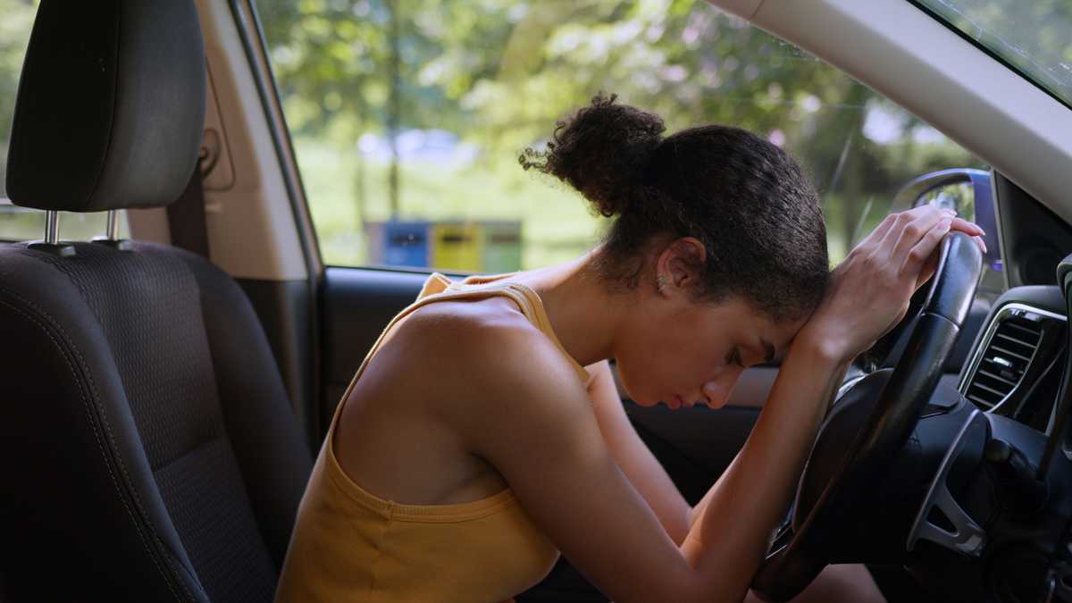 Single mother discovering cash in the trunk of a used car on a Lagos street