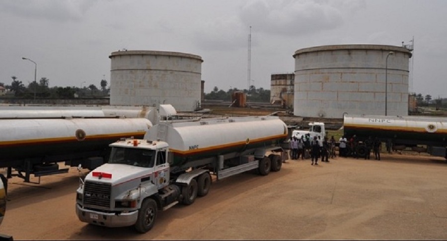 Tanker trucks parked along a Nigerian highway at dusk