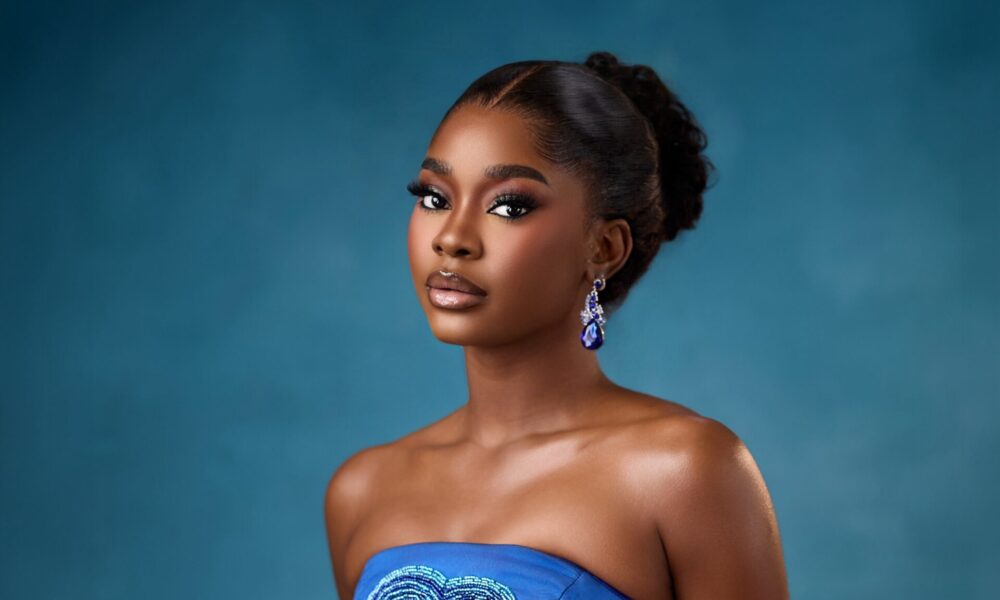 Royal blue satin gown with heart‑shaped beaded cutout displayed at a Lagos wedding venue