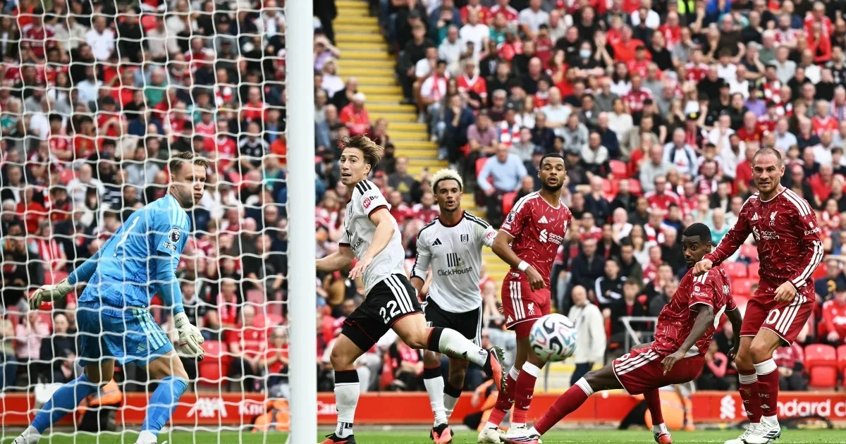 Anfield Stadium under floodlights with a diverse African-Nigerian fan crowd celebrating the Premier League season