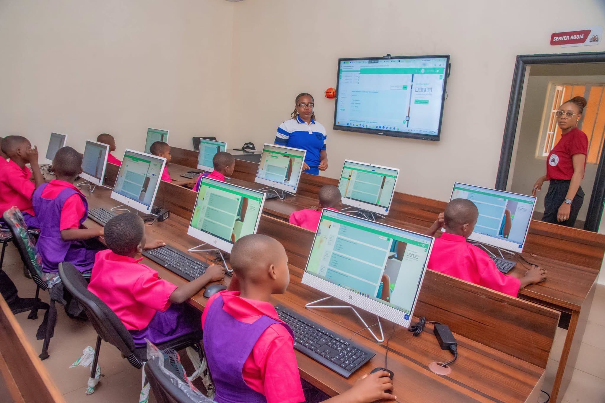 A teacher using digital tools in a modern Nigerian classroom with interactive technology