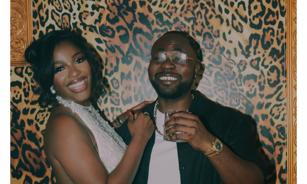 A stylish woman wearing a white beaded mini dress posing confidently at a party venue in Lagos, Nigeria, representing the Hilda Baci birthday look with elegant African-inspired fashion.