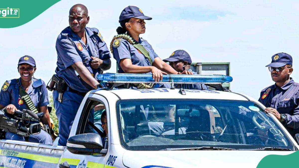 Police officers in South Africa securing a handcuffed suspect near a vehicle