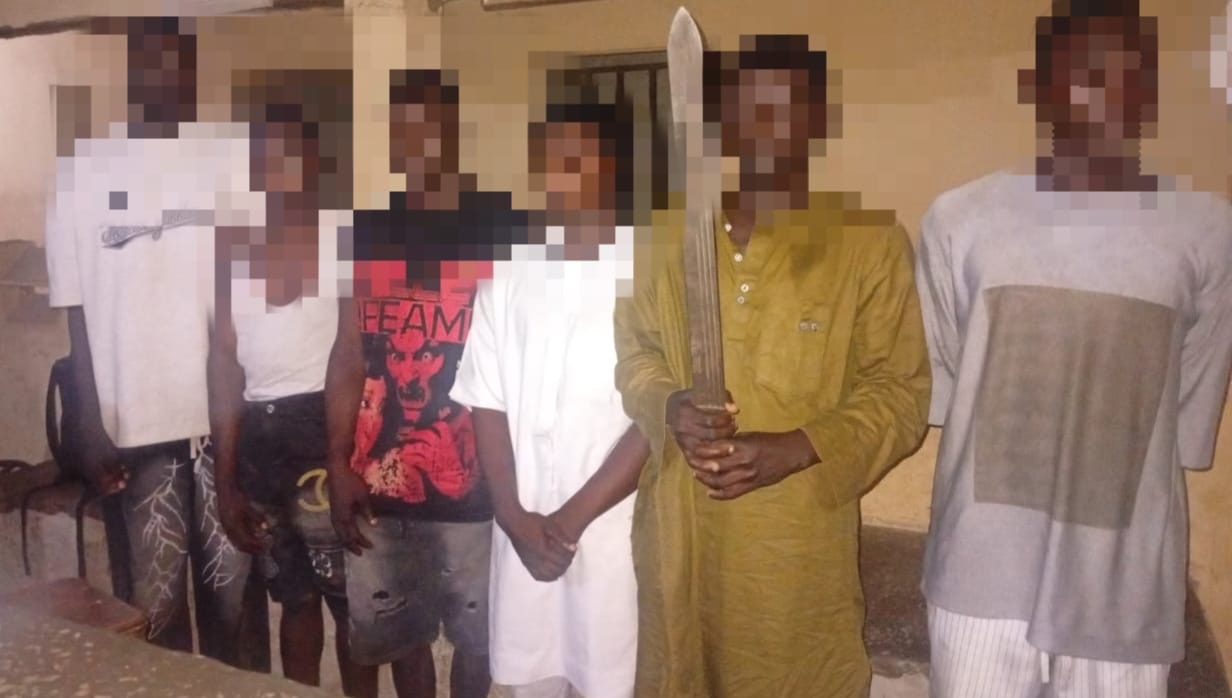 Nigerian police officers in tactical gear during a raid on a suspected crime syndicate.