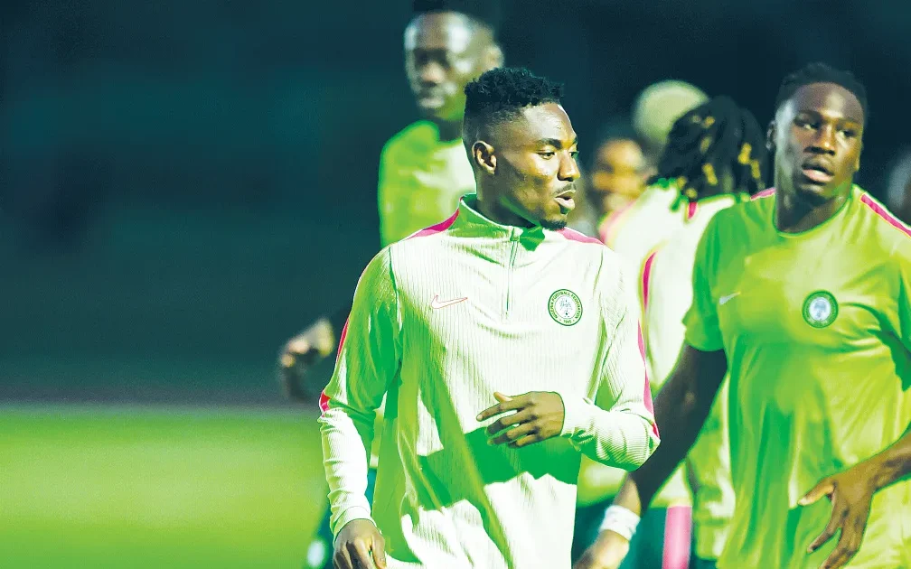Uyo football training ground with Nigerian flag and lush surroundings