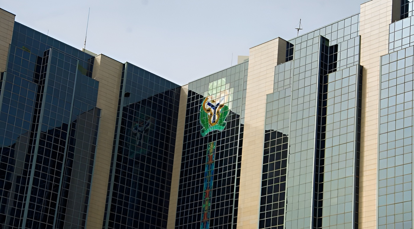 Central Bank of Nigeria building overlooking a busy Lagos street at dusk