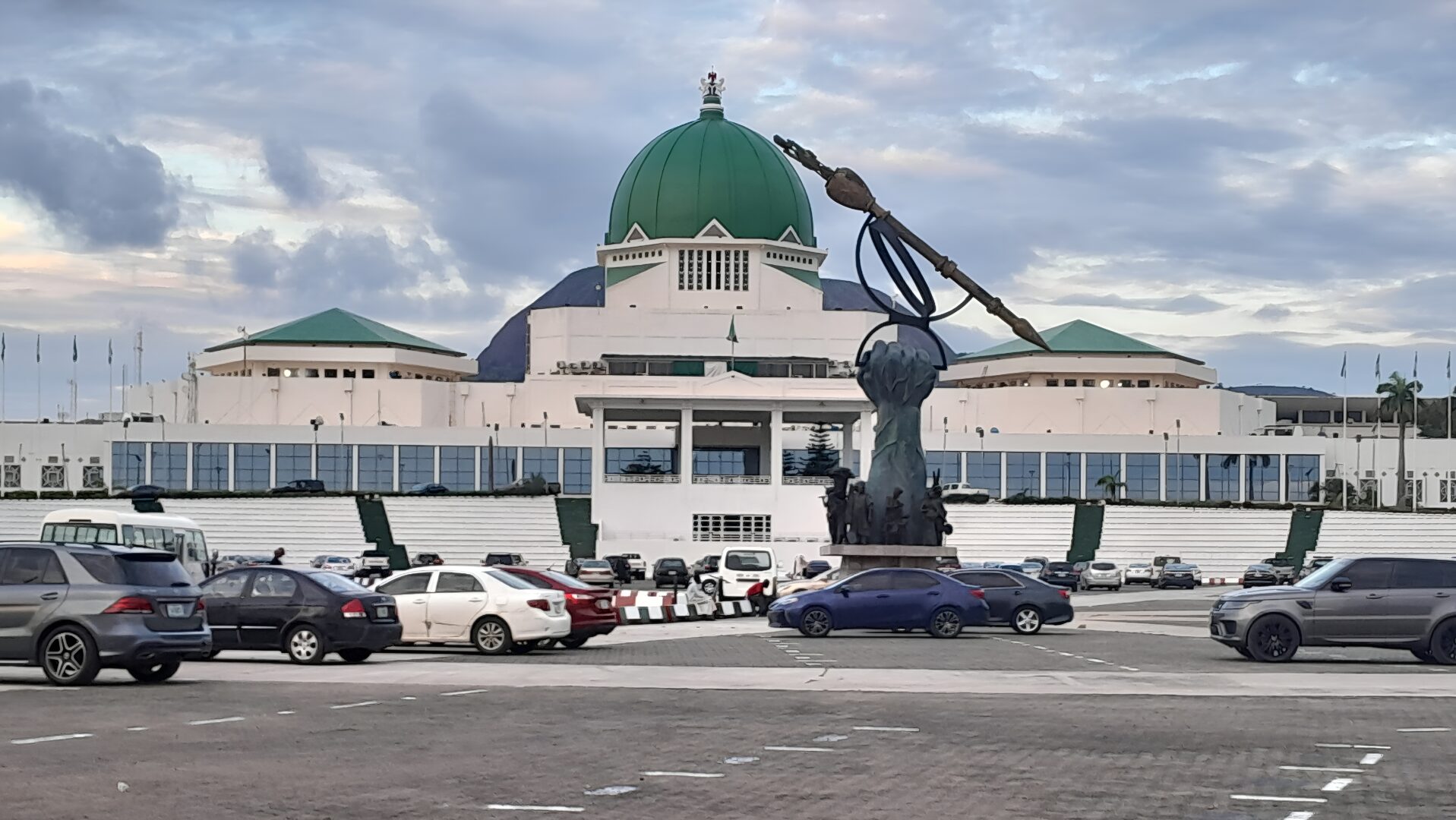 The Nigerian National Assembly complex in Abuja at golden hour, symbolising legislative governance and constitutional reform.