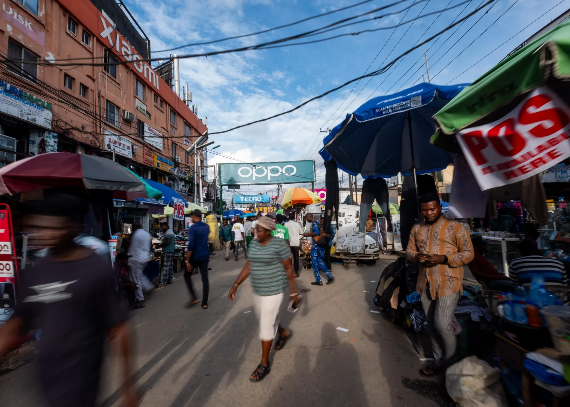 Nigerian cityscape showing a bank and a small business, symbolising the link between monetary policy and SME lending.