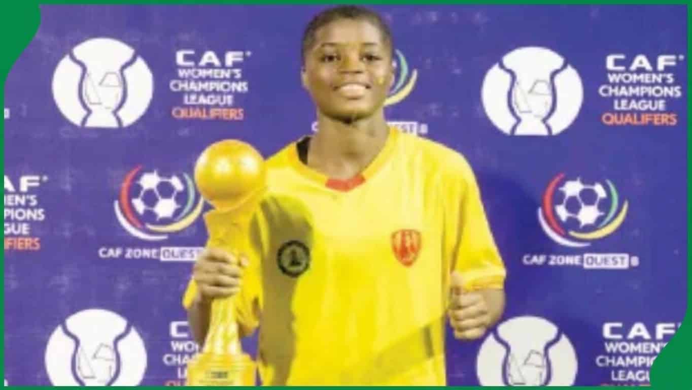 Young female footballer celebrating victory with teammates on a pitch under stadium lights, African backdrop