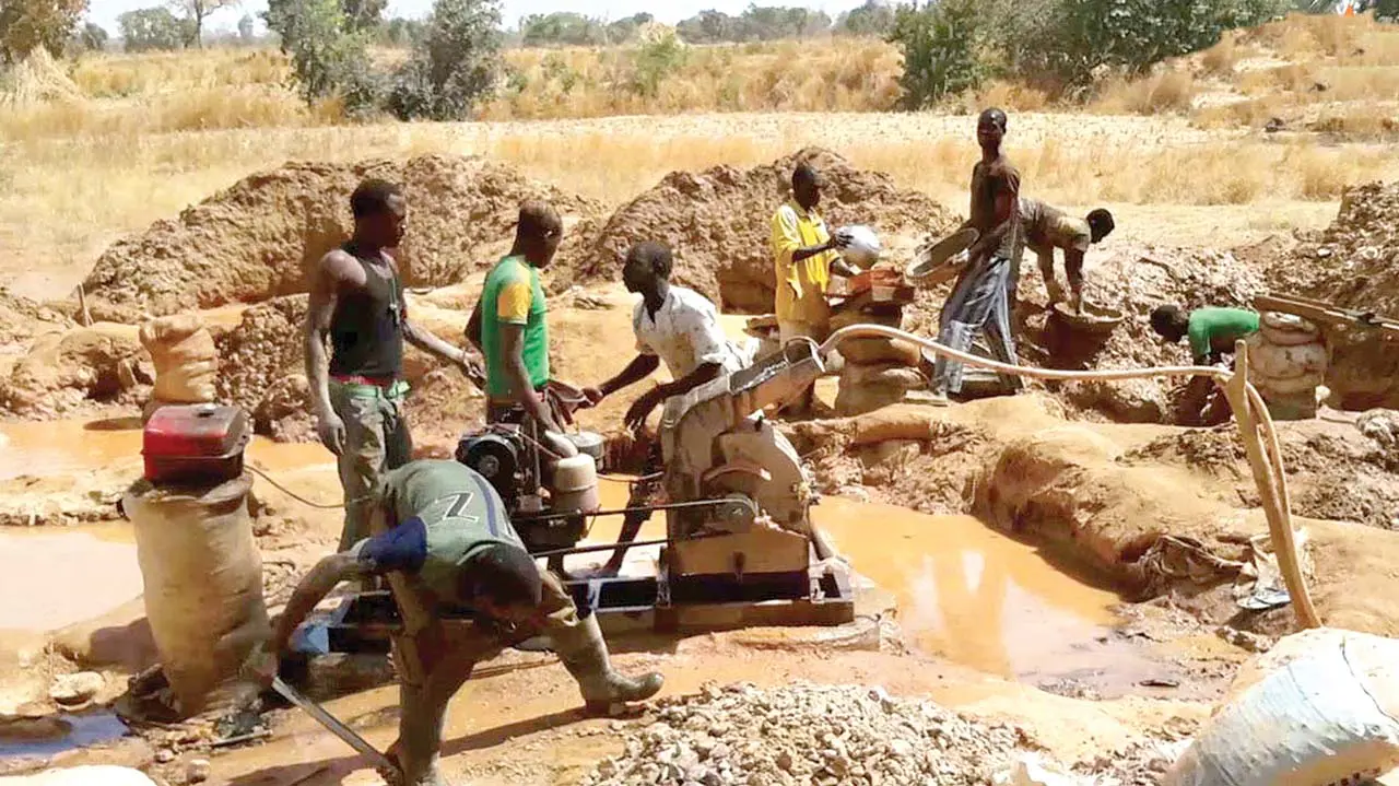 Rocky mining pit in Kogi State with abandoned equipment at sunrise