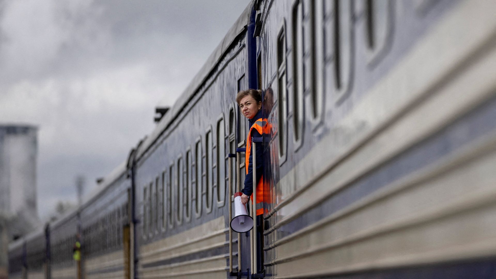 Reinforced Ukrainian freight train operating on damaged tracks during active conflict
