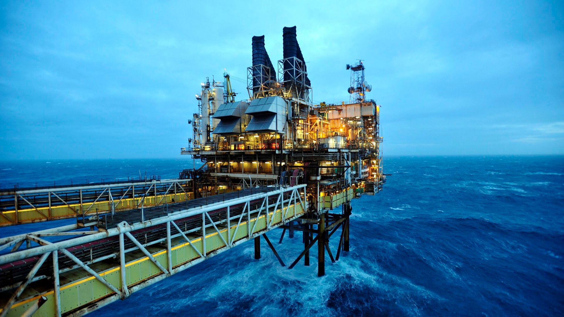 Offshore wind turbines and oil rigs over the UK sea horizon
