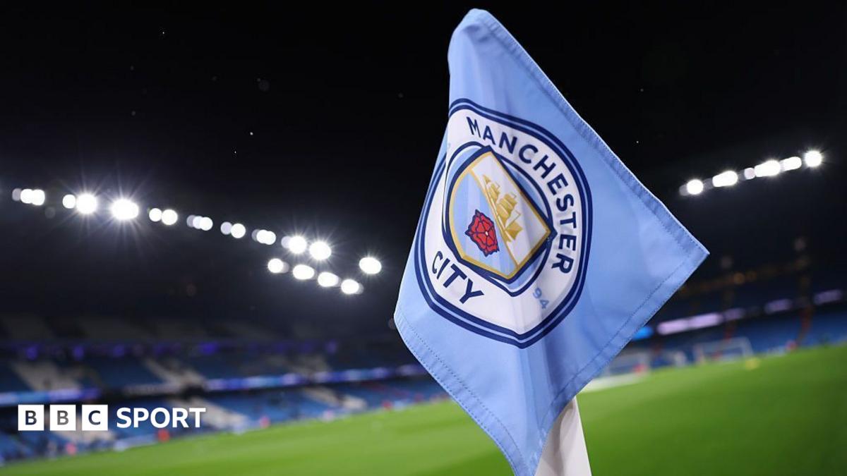 Empty football stadium under floodlights, symbolising scrutiny of financial rules.