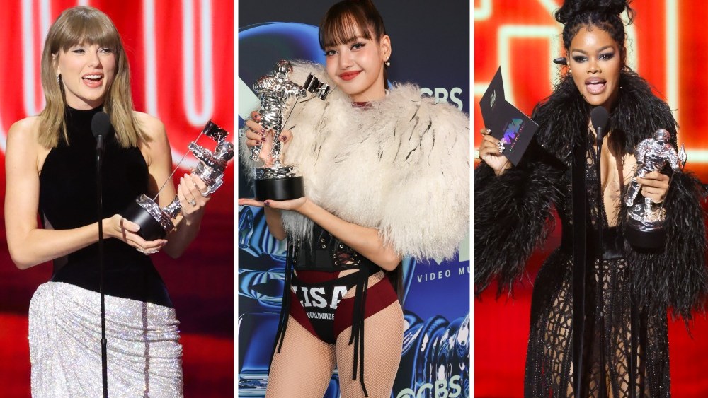 A glamorous red carpet stretching into the distance under dramatic evening lighting at a major awards ceremony