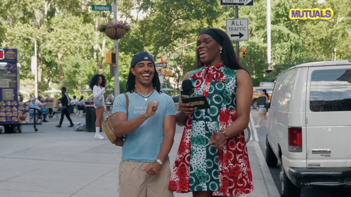 Two creators in a vibrant studio practicing a Kardashian‑style voice for a Gaydar episode