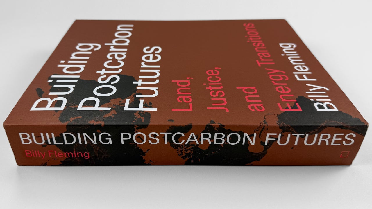 Solar fields, wind turbines, and a carbon‑capture plant under a sunrise sky
