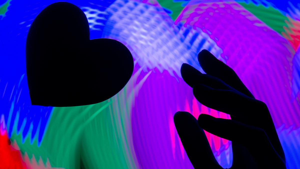 Two smartphones showing dating app interface with romantic ambient lighting
