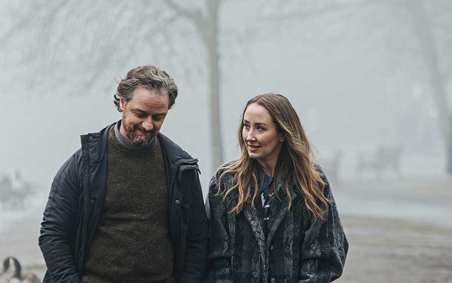 Rain‑soaked London street at night, evoking the somber tone of Faith film review