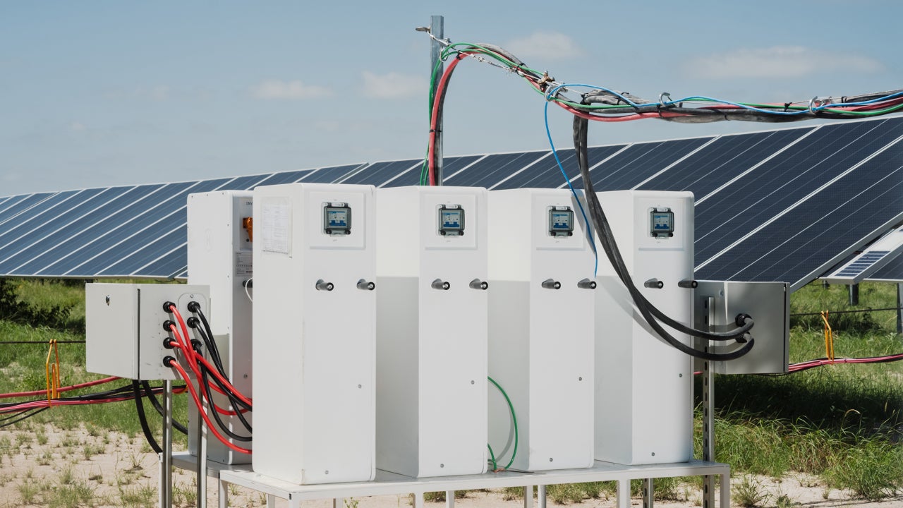 Solar‑direct AI data center beside a sprawling solar farm in a desert landscape