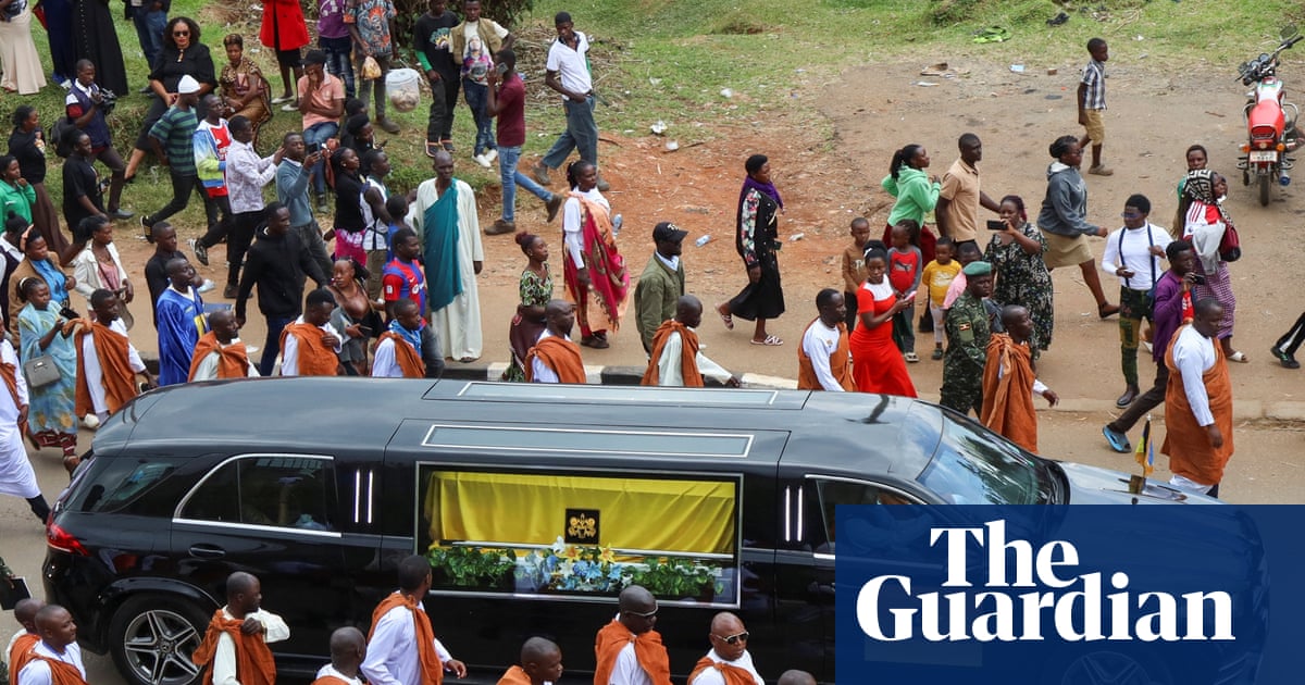 Royal guards escorting a casket through Fort Portal during the burial of King Oyo.