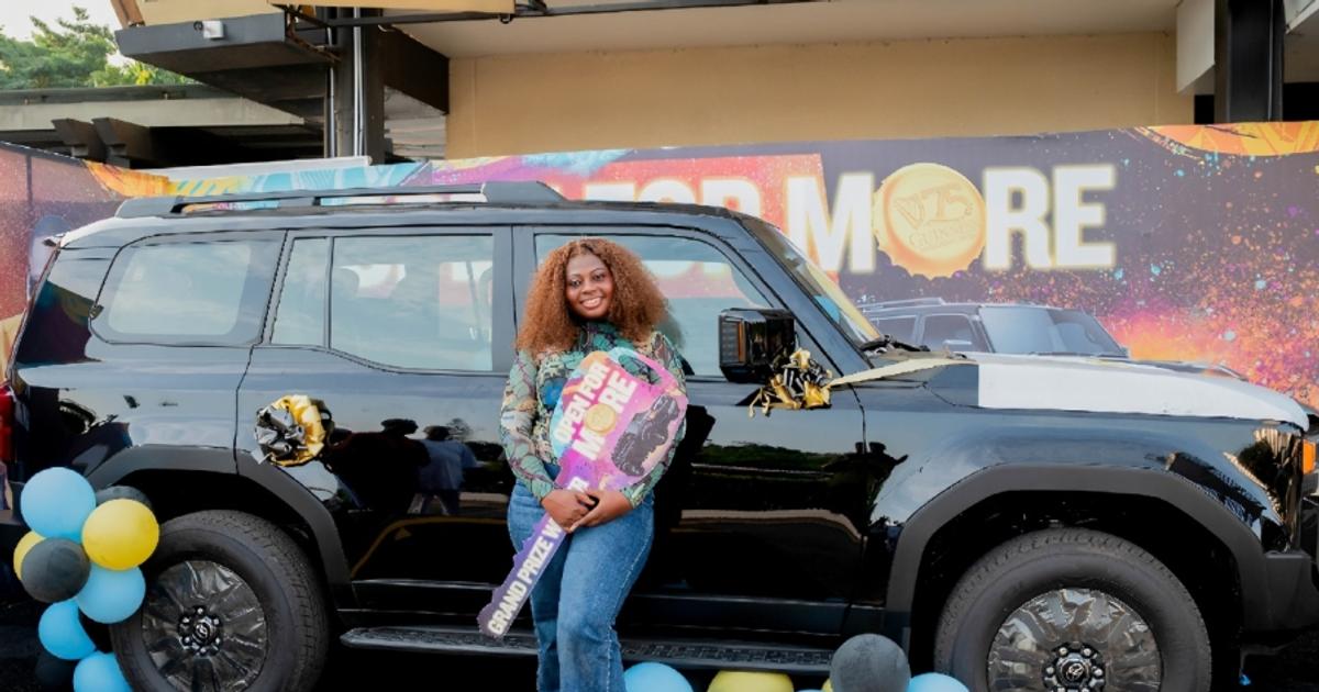 Lagos street market with a bottle of Guinness on a crate, hinting at celebration.
