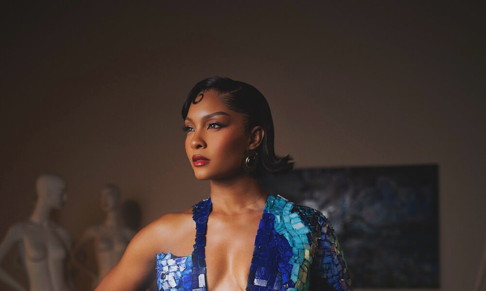 Blue mosaic gown with shimmering mother-of-pearl details displayed in studio lighting