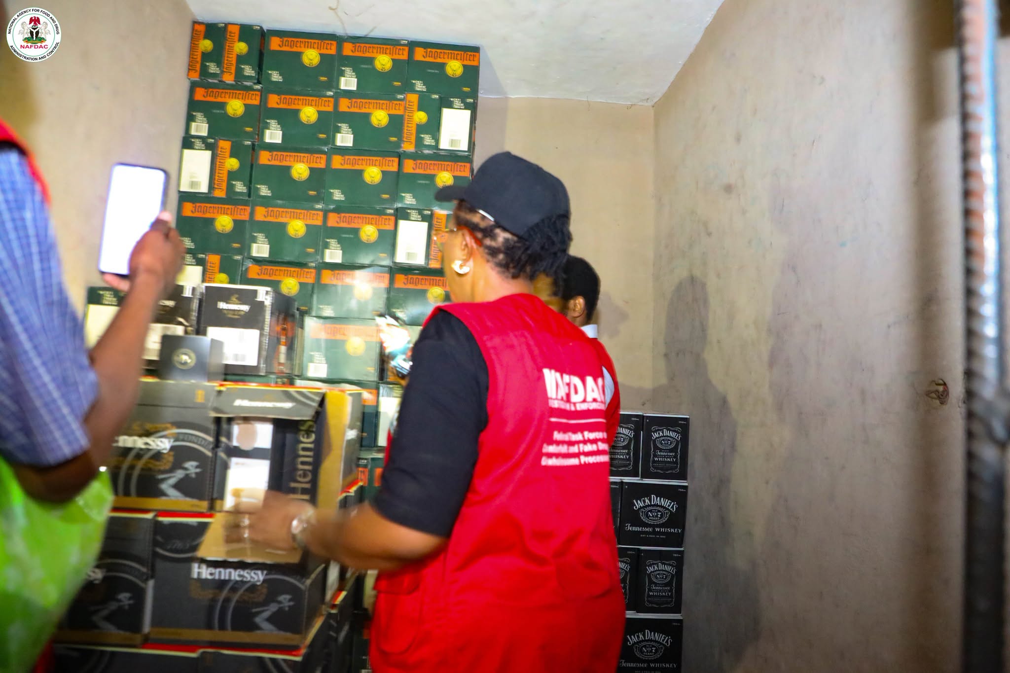 Lagos market scene with NAFDAC officers inspecting beverage crates during a raid