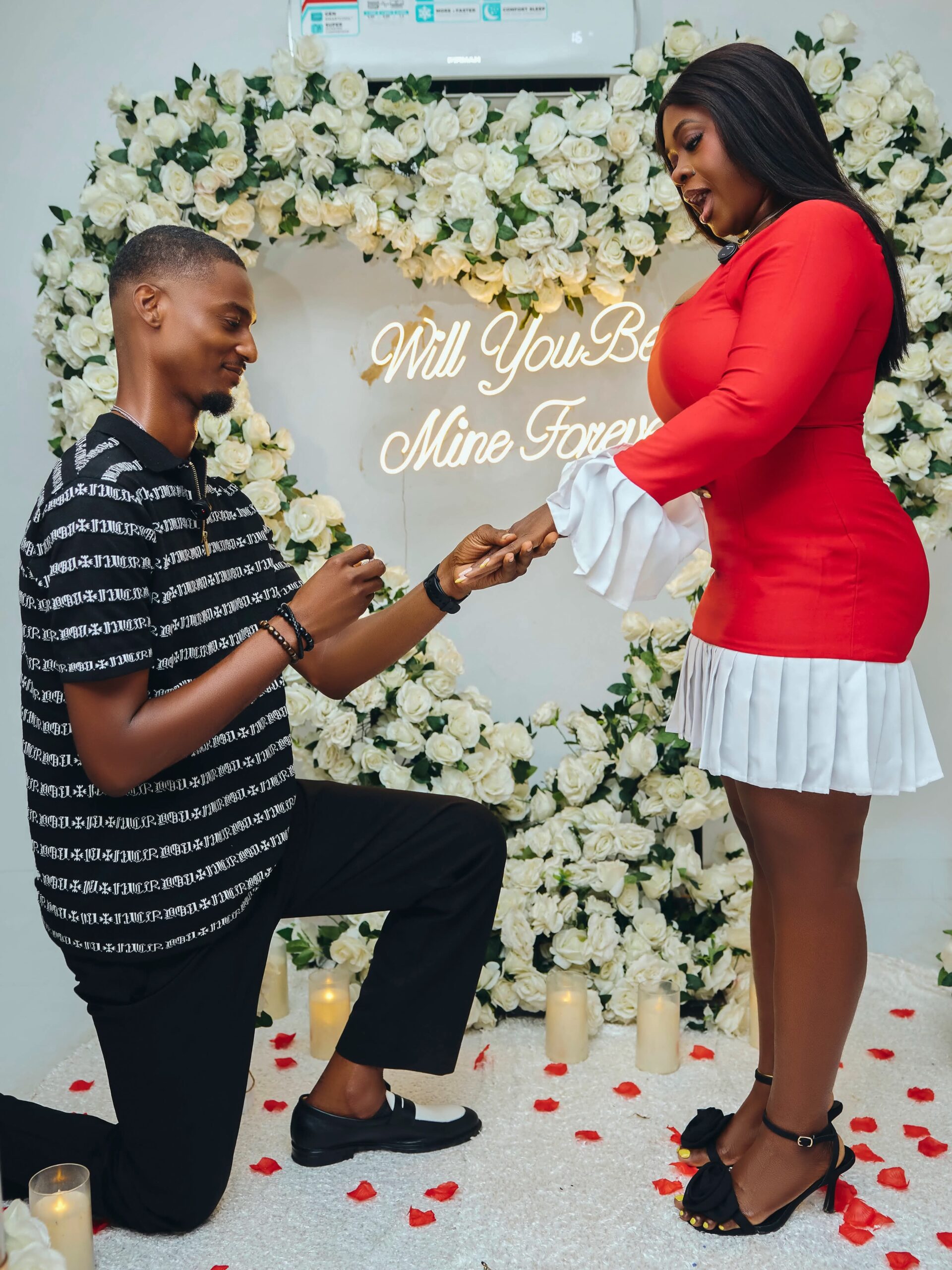 Nigerian couple celebrating engagement with traditional decorations at sunset