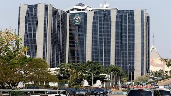 Lagos financial district with naira and calculator representing Nigeria's economic policy