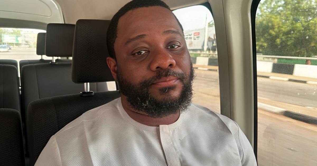 Abuja residential street with police presence after a land fraud investigation