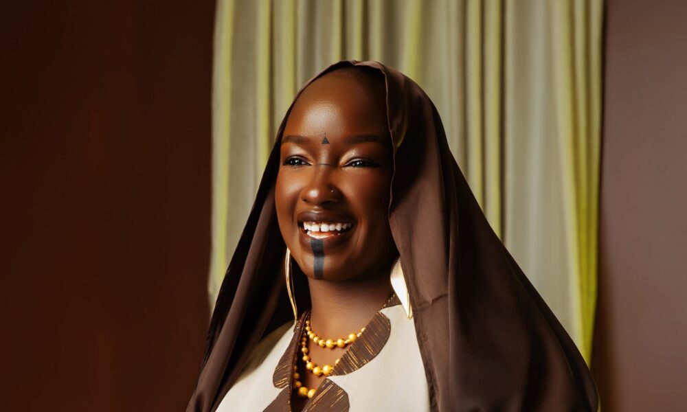 Elegant Nola kaftan displayed on a runway, representing the fusion of African fashion and European academic celebration.