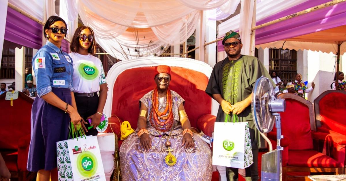 Evening view of the Ofala Festival with traditional masquerades and illuminated stalls in Onitsha
