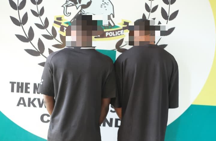 Police patrol cars on a quiet Uyo street after arrests related to machete attacks