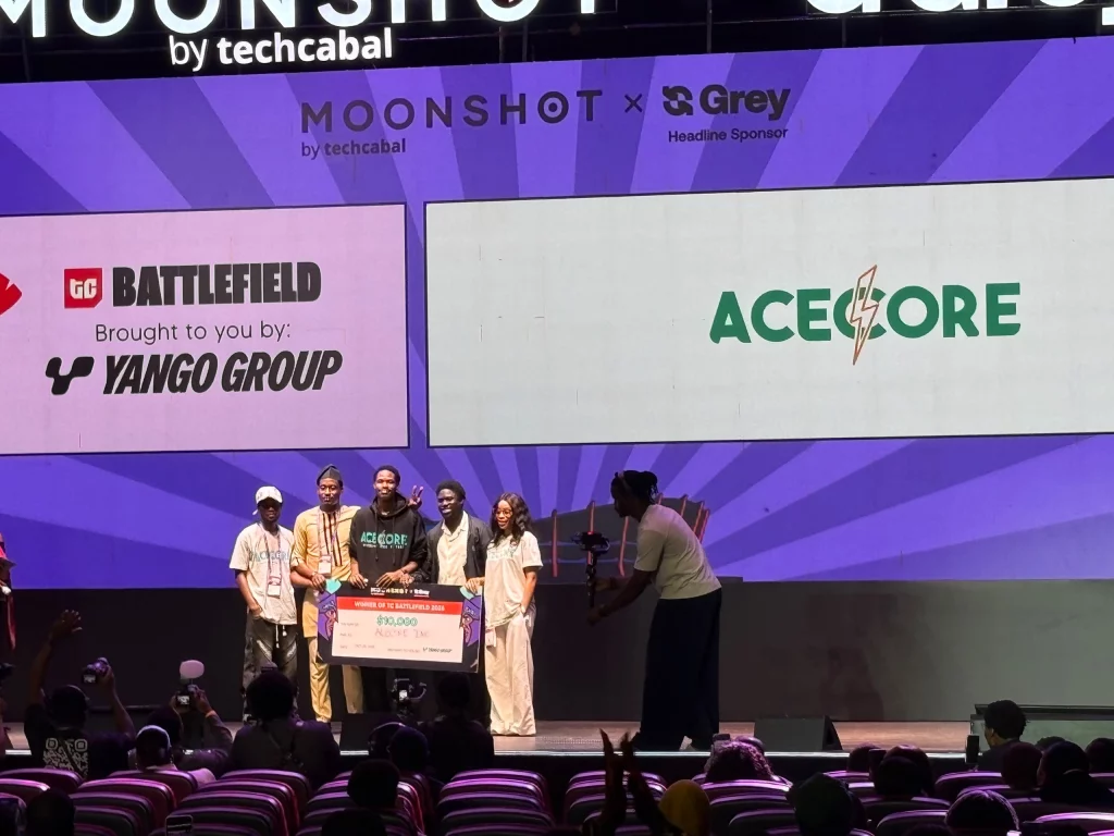 Lagos co‑working space with Moonshot prize banner and developers collaborating