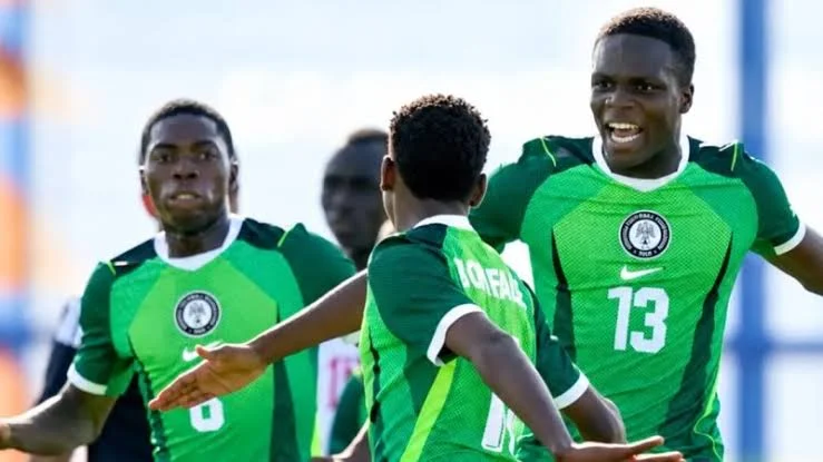 Nigerian U‑15 football team celebrating a victory on the pitch
