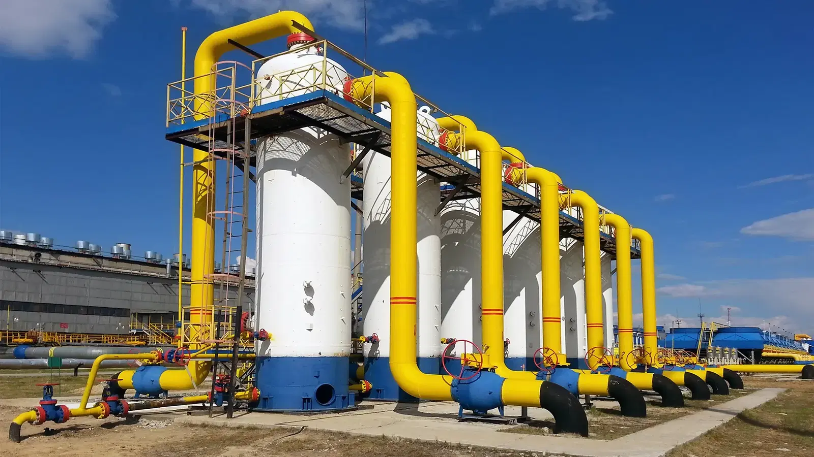 Nigerian gas processing plant juxtaposed with a residential area, highlighting the gap between industrial export and household consumption.